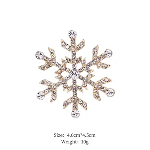 Close-up of golden snowflake brooch with sparkling rhinestones and crystal center detail