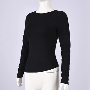 Detail of black slim-fit long sleeve top with crew neck on a mannequin display