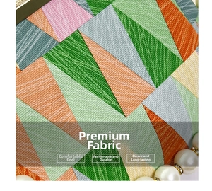 Detail of colorful geometric pattern handbag with textured fabric and pearl chain strap