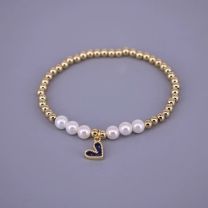 Elegant beaded bracelet featuring gold balls, white pearls, and a blue zircon heart pendant