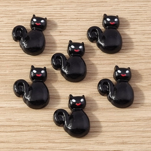 Macro detail of six black glossy resin cat figurines for Halloween DIY crafts on wood