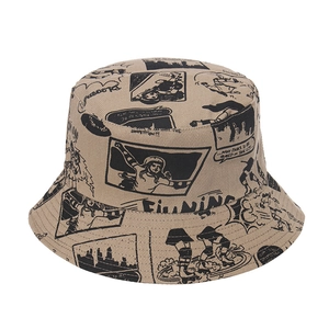 Detailed view of beige canvas bucket hat with black vintage comic book character prints