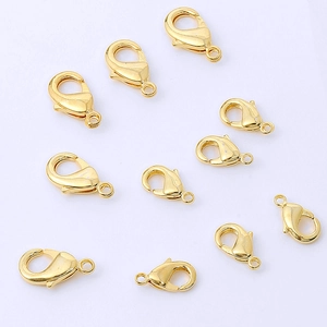 Detailed close-up of ten gold-plated lobster clasps for DIY jewelry making