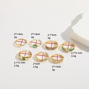 Set of seven gold adjustable rings with green emerald and clear cubic zirconia stones