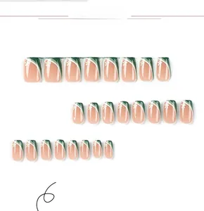 Detail of green and pink press-on nails with floral patterns and French design