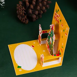 3D pop-up Christmas card featuring a festive tree and bear on a yellow backdrop