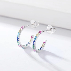 Detail of 925 sterling silver hallmark on C-shaped earrings with colorful zircon stones