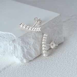 Close-up of S925 sterling silver stud earrings showing the 925 authenticity hallmark