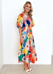 Close-up of floral print V-neck dress with puff sleeves and vibrant summer patterns