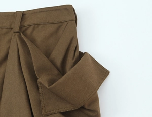 Detailed macro view of brown cargo skirt twill fabric with belt loops and flap pocket