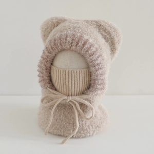 Close-up of plush baby balaclava with cute bear ears and integrated knit mask