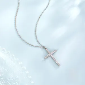 Macro detail of S925 sterling silver cross pendant with sparkling zircon stones