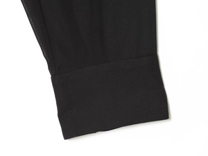 Detailed view of black chiffon fabric texture and stitching on an elegant blouse