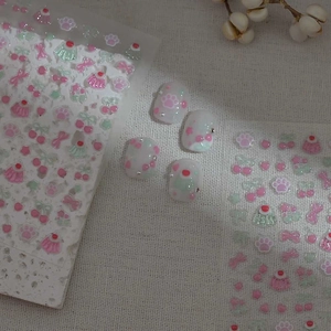 Cute pink cat paw and cherry nail stickers with 3D rhinestone nail art on white fabric