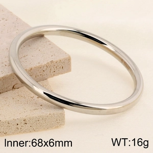 Close-up of a 6mm silver stainless steel bangle with S. Steel hallmark on a stone base