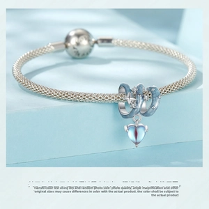 Close-up of S925 sterling silver mesh bracelet with blue enamel heart charm and pavé detail