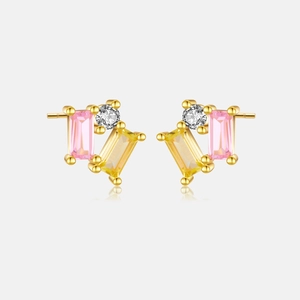 Detailed macro view of S925 silver stud earrings with pink and yellow baguette gems