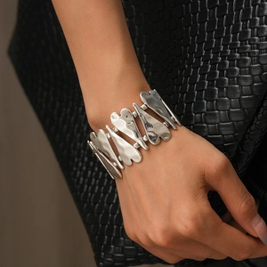 Détail d'un bracelet vintage en argent avec cœurs sur poignet et fond texturé élégant