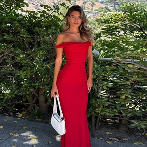Detail of red off-shoulder mermaid dress showing elegant bodycon fit in outdoor setting