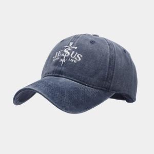 Detail of navy washed cotton baseball cap with white Jesus Saved My Life embroidery
