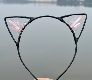 Detail of pink crystal stones hand-wrapped on black cat ear headband with silver wire