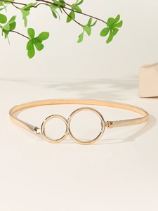 Detail shot of golden metal stretch belt with double ring buckle and spring design