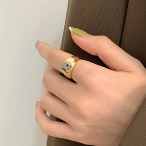 Detail of 925 silver gold-plated ring featuring a unique zebra stone on model hand