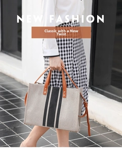 Close-up of gray canvas tote bag with brown leather handles and vertical stripes