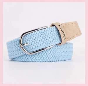 Detail of light blue elastic woven belt with metal D-ring buckle and beige leather trim