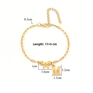 Detailed view of golden bow and letter M bracelet with size measurements 17+5cm