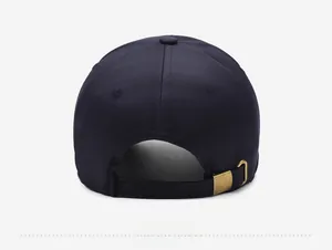 Detail view of navy blue baseball cap back with vintage brass adjustable buckle and strap