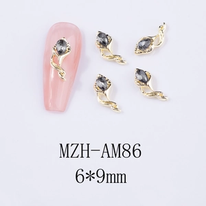 Macro shot of 3D horse-hoof flower nail charms with grey teardrop rhinestones