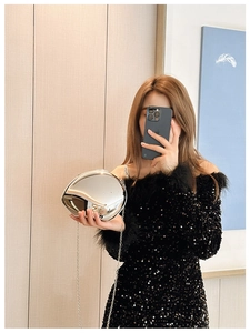Chic silver metallic pebble-shaped evening bag with a slender chain shoulder strap