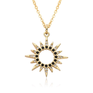 Detail of gold starburst pendant necklace with black and white crystal inlay