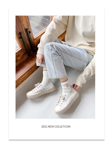 Detailed side view of off-white platform sneakers with round toe and cream rubber sole
