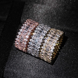 Set of four stacked eternity rings with rose gold and silver bands inlaid with cubic zirconia