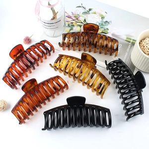 Set of 7 oversized vintage matte and tortoiseshell hair claws on a white desk