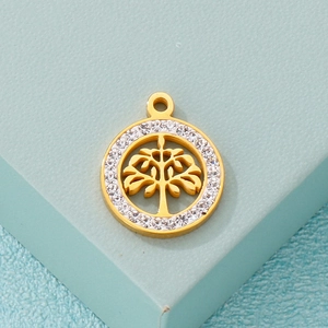 Golden Tree of Life pendant with sparkling crystals on a minimalist blue pedestal