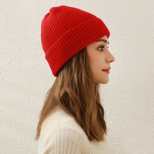Classic red knitted beanie hat for women featuring a cozy turn-up cuff design
