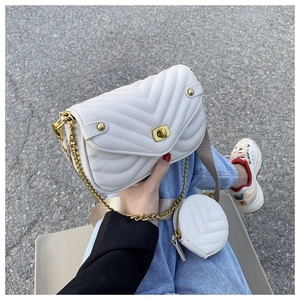 Detail view of white V-quilted crossbody bag with gold chain and mini round coin purse