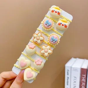Close-up of 10-piece kids hair ties featuring cute resin fruit and animal charms