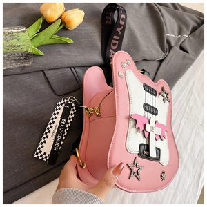 Detailed macro view of pink guitar-shaped crossbody bag with decorative rivets and stars