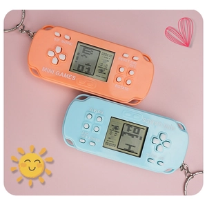 Detail of mini Tetris game console keychains in orange and blue with LCD screens