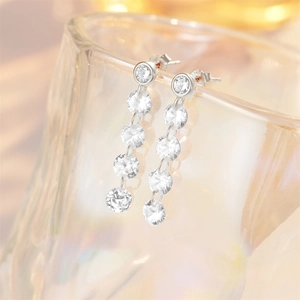 Macro view of long silver tassel earrings featuring five sparkling round rhinestones