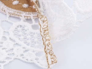 Detailed close-up showing white lace stitching on brown fabric with precise seam finish