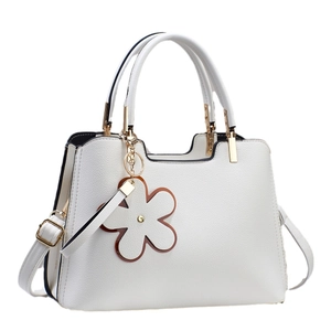 Elegant white litchi leather handbag for women with gold hardware and floral charm accessory