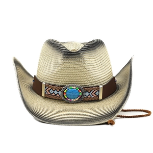 Detail of straw cowboy hat featuring blue turquoise stone and ethnic beaded leather band
