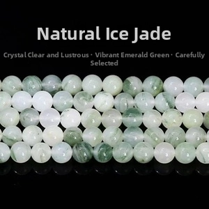 Macro detail of natural Bingcui jade beads with green patterns on a smooth surface