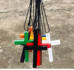Detailed macro view of colorful wooden cross pendants with black metal bead chains