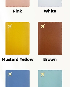Close-up of multicolored PU leather passport holders with gold airplane logo and lychee texture